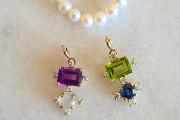 Left to right: Amethyst & Moonstone; Peridot & Sapphire. Set with Moissanites all around.