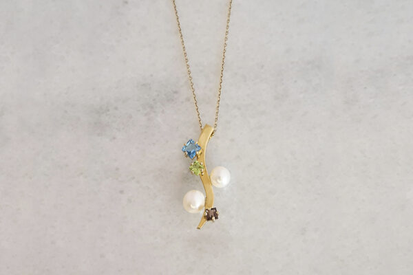 18k gold pendant; freshwater pearls, blue topaz, peridot & smoky quartz.