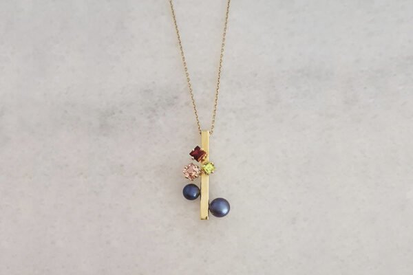 18k gold pendant; Tahiti pearls, garnet, tourmaline & peridot.